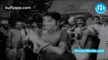 a black and white photo of a group of people dancing .