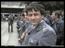a group of men in military uniforms are standing in a line