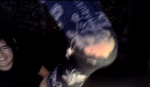 a blurry picture of a person wearing headphones and a shirt that says ' a ' on it