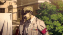 a man with a beard is talking on a cell phone while wearing a white suit .