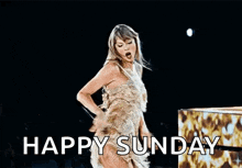 taylor swift is singing into a microphone on a stage while wearing a dress .