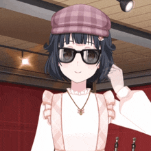 a girl with glasses and a plaid hat