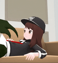 a girl wearing a black hat with a triangle on it is laying on a couch