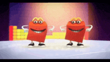two mcdonald 's happy meals are dancing together on a stage