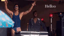 two men are dancing in front of a keyboard with the word helloo on the bottom