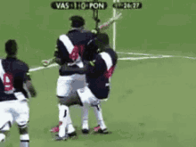a group of soccer players on a field with a scoreboard that says vas 1:0 pon