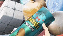 a person is holding a can of pringles in their hands