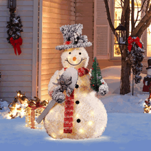 a snowman with a top hat and scarf holding a christmas tree