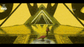 a person is dancing on a stage in front of a pyramid .