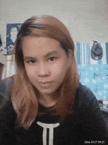 a woman wearing a black shirt with a white t on it