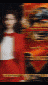 a blurred image of a person in a red dress