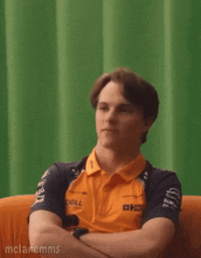 a young man wearing a dell shirt is looking at the camera
