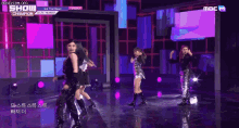 a group of girls are dancing on a stage with a sign that says show champion on it