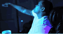 a man is sitting in a chair with his arm outstretched