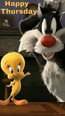 tweety and sylvester from the looney tunes movie are dancing on a wooden table .