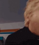 a close up of a person 's face with a striped background .