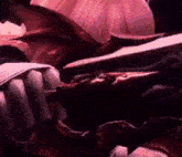 a close up of a person holding a sword in their mouth in a dark room .