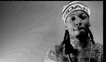 a black and white photo of a man wearing a headband with the word adam on it