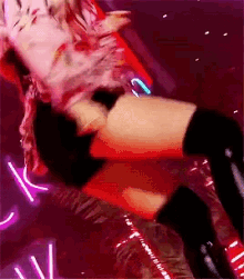 a woman in a red dress and black thigh high socks is dancing