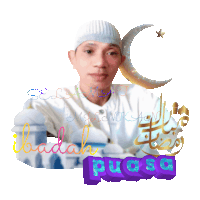 a man wearing a white hat with a crescent moon and the word puasa