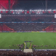 a soccer stadium with coca cola and tcl advertisements