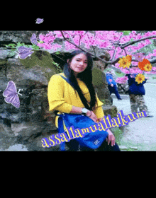 a woman in a yellow shirt is surrounded by pink flowers and butterflies and has the words assalamualaikum on the bottom