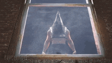a man with a pyramid head looking out a window