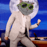 a man in a suit with a cat on his head wearing green sunglasses