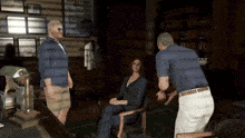 a man in a blue shirt is talking to a woman in a chair