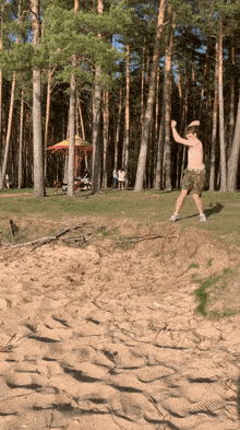 a shirtless man is throwing a frisbee in the air