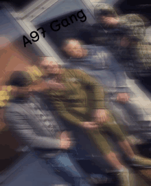 a group of men are standing in front of a wall that says a97 gang on it