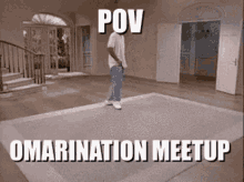 a man is standing on a rug in a living room with a caption that says pov omarnation meetup .