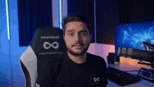 a man sitting in a maxnomic creatorgalaxy chair