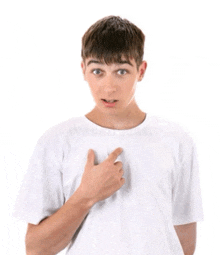 a young man in a white t-shirt points to his chest