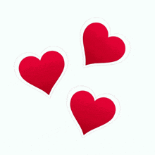 three red hearts are on a white background