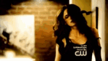 a woman wearing a black shirt that says cw