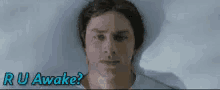 a man is laying in bed with the words " ru awake " written above him