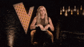 a woman with long blonde hair is making a funny face with her mouth open