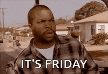 a man in a plaid shirt says it 's friday in front of a house .