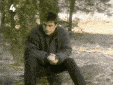 a man sitting on a rock with the number 4 on the bottom