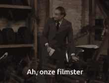 a man in a suit says ah onze filmster in a warehouse