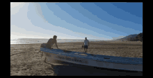 a man sits in a boat on the beach with the number 1601066912 on the side of it