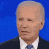 a man in a suit and tie is making a funny face
