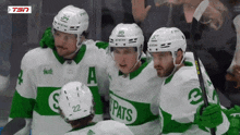 a group of hockey players wearing green and white jerseys with the word pats on the front