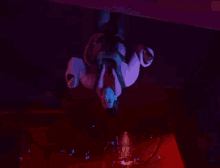 a man in a pink coat is reaching for something in the dark