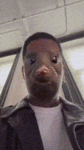 a man with a cat 's face on his face looks at the camera .