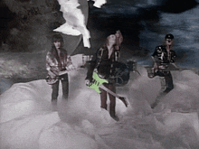 a man with a green guitar is standing in the middle of a group of people