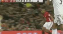 a soccer player jumps in the air to catch the ball during a game