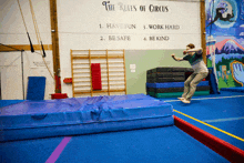 a sign that says " the rules of circus " hangs on a wall