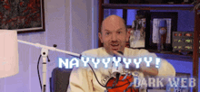 a man sitting in front of a microphone with the words nayyyyyy dark web on the bottom right